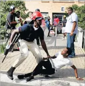  ?? PICTURE: MOTSHWARI MOFOKENG ?? Police and security chase protesting students at the UKZN Westville campus today after they burned cars and the senate chamber building.