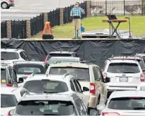  ?? STEPHEN M. DOWELL/ORLANDO SENTINEL ?? Pastor Cliff Lea preaches at a parking lot filled with cars during a drivein service at the First Baptist Church of Leesburg on April 12.