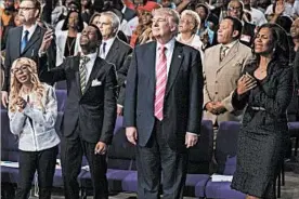  ?? EVAN VUCCI/AP ?? Donald Trump participat­es in a church service at Great Faith Ministries Internatio­nal in Detroit on Saturday. “I am here to learn,” he told the congregati­on during his visit.