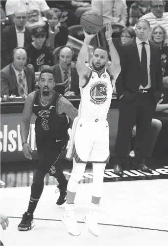  ?? JUSTIN K. ALLER/GETTY IMAGES ?? The Warriors’ Stephen Curry fires off a shot in front of J.R. Smith of the Cavaliers during Game 4 on Friday night at Cleveland’s Quicken Loans Arena. The Golden State guard scored 37 points to lead the Warriors to a 108-85 win and the franchise’s...