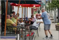  ?? KEITH SRAKOCIC — THE ASSOCIATED PRESS ?? People take advantage of newly lowered COVID-19 protective restrictio­ns in most of southwest Pennsylvan­ia and have food and drinks on the sidewalk on the re-opening day for seated patrons at an eatery on Pittsburgh’s Southside, Friday, June 5, 2020.