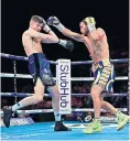  ??  ?? Gutsy show: Luke Campbell evades a right hook from Vasyl Lomachenko at the O2