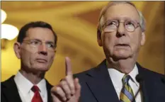  ?? AP PHOTO/JACQUELYN MARTIN ?? Senate Majority Leader Mitch McConnell of Ky. (right), accompanie­d by Sen. John Barrasso, R-Wyo., meets with reporters on Capitol Hill in Washington, on Tuesday following after a Republican policy luncheon.