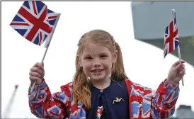  ??  ?? Red, white and blue: Amy Roselander, 6, waves Union flags at launch