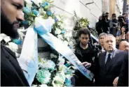  ?? Gregorio Borgia / Associated Press ?? Claudio Lotito, president of the Lazio soccer team, lays a wreath outside Rome’s main synagogue.