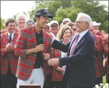  ?? The Associated Press ?? START WITH SCHWAB: Kevin Na, front left, is congratula­ted by Charles Schwab May 26, 2019, after winning The Charles Schwab Challenge at Colonial in Fort Worth, Texas. The PGA Tour laid out an ambitious plan to resume its season Thursday with hopes of a restart at Colonial on June 11-14 and keeping fans away for at least the first month.