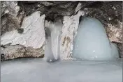  ?? PTI ?? Restoratio­n of Amarnath Yatra track. (right) Naturally formed Shiv Lingam (ice-lingam) in the holy cave shrine of Amarnath