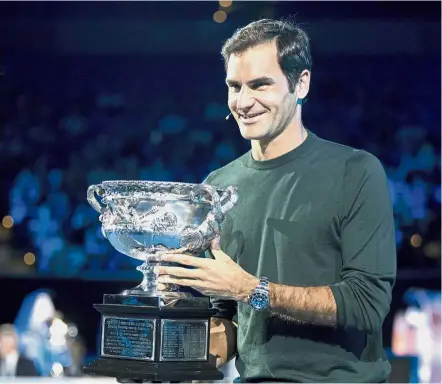  ??  ?? Formidable player: Defending men’s singles champion Roger Federer posing with his trophy during the official draw ceremony of the Australian Open in Melbourne yesterday.