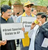  ?? PTI ?? Telugu Desam MPs Naramalli Sivaprasad, Murali Mohan Maganti and Jayadev Galla stage a protest demanding special status for Andhra Pradesh during Budget Session at Parliament House in New Delhi on Thursday. —