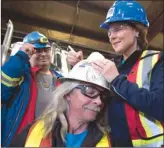  ?? The Canadian Press ?? B.C. Liberal Leader Christy Clark signs a worker’s helmet as she makes a campaign stop at Inland Concrete in Fort St. John on Tuesday.