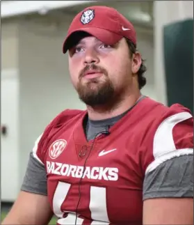  ?? Craven Whitlow/Special to News-Times ?? Big man on campus: Arkansas defensive lineman Austin Capps talks to reporters Saturday during the team's media day.