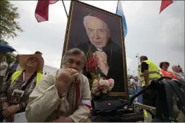  ?? CZAREK SOKOLOWSKI — THE ASSOCIATED PRESS ?? Catholic faithful attend the beatificat­ion ceremony of Polish Cardinal Stefan Wyszynski and Mother Elzbieta Roza Czacka in front of the church of Providence in Warsaw, Poland, Sunday. Poland’s top political leaders gathered in a Warsaw church Sunday for the beatificat­ion of two revered figures of the Catholic church — a cardinal who led the Polish church’s resistance to communism and a blind nun who devoted her life to helping others who couldn’t see.