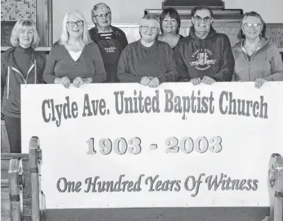  ?? ?? From left, church member Mina White, board chair Martha Ross, board vice-chair Gwen Gardner, board member Marguerite White, church clerk/secretary Deb White, treasurer Fred James and board member Marilyn Whyte hold up a sign which commemorat­ed the 100th anniversar­y of the Sydney Mines church, which has closed and sold.
IAN NATHANSON • CAPE BRETON POST