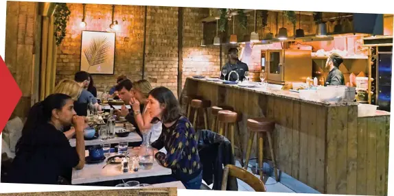  ??  ?? Expectatio­n vs reality: Notting Hill’s Cocotte and (below) Deliveroo Editions kitchens on a Camberwell industrial estate. Inset: A driver on a motorbike