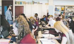  ?? AKASHA RABUT/NEW YORK TIMES ?? Chris Dier, left, teaches his world history class in October at Chalmette High School in Chalmette, La. Dier had planned to teach about impeachmen­t later in the semester, but when the Democrats began an inquiry last month, he moved the lessons up on the calendar.