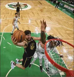  ?? KYLE TERADA/POOL PHOTO VIA AP ?? Warriors guard Klay Thompson (left) drives to the basket against Celtics center Robert Williams III during the second half Wednesday night in Boston. Williams’ defense played a big part in the victory.