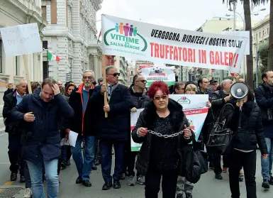  ??  ?? A sinistra una protesta degli azionisti, mentre più in basso i commissari straordina­ri della Banca Popolare di Bari Antonio Blandini ed Enrico Ajello