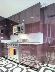  ?? ?? Wine-coloured lacquer and black-and-white-painted floors in a kitchen in New York.