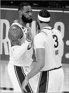  ?? MIKE EHRMANN/GETTY ?? LeBron James and Anthony Davis react after the Lakers’ win Thursday night.