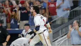  ?? JOHN BAZEMORE — THE ASSOCIATED PRESS ?? Atlanta Braves’ Dansby Swanson (7) yells after scoring the game-winning run on a Rio Ruiz base hit during the ninth inning against the New York Mets Friday in Atlanta.