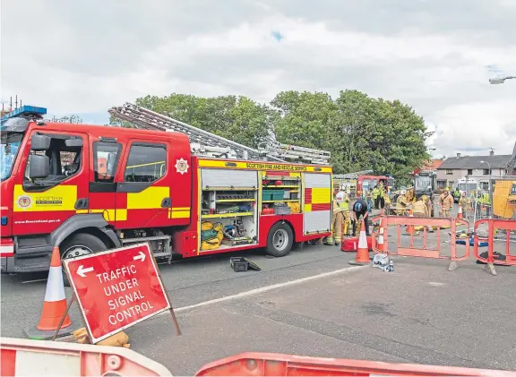  ?? Pictures: Steven Brown. ?? Police, fire and ambulance personnel on the scene where a workman was trapped down a hole on a building site on Napier Road, Glenrothes.