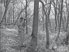  ??  ?? Randy Edwards of the Nature Conservanc­y snaps a picture of the view at Smokey Hollow Preserve in Adams County.