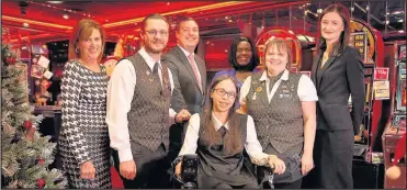  ??  ?? Emma Taylor with her new wheelchair courtesy of fundraisin­g at Hinckley gaming centre Cashino on Castle Street. She is pictured with her mum Carolyn and staff.