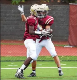  ?? PETE BANNAN — DIGITAL FIRST MEDIA ?? Junior running back/cornerback Nate Whitaker, left, is congratula­ted by Haverford School teammate Conner Mosebrook after his second quarter touchdown in Saturday’s 48-28 win over Penn Wood.