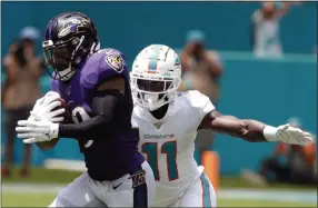  ?? WILFREDO LEE - THE ASSOCIATED PRESS ?? FILE - In this Sept. 8, 2019, file photo, Baltimore Ravens free safety Earl Thomas (29) intercepts a pass, as Miami Dolphins wide receiver DeVante Parker (11), attempts to tackle, during the first half at an NFL football game, in Miami Gardens, Fla.