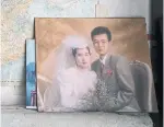  ??  ?? A wedding photo of Han's younger son is displayed in Han's home. The son's family migrated to Canada in 2003.