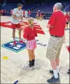  ?? CONTRIBUTE­D ?? Dayton’s DaRon Holmes II works with kids at a basketball camp at UD Arena.