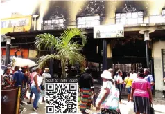  ?? ?? Passers-by look at what remains of the shopping mall at corner of Julius Nyerere Way and Agostinho Neto Avenue in Harare after it was destroyed by fire on Sunday. — Picture: Tinashe Chitwanga