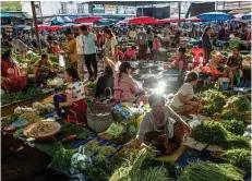  ??  ?? A bustling produce market in Pakse, Laos. Pakse is the second most populous city in Laos.