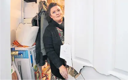  ?? Picture: Gareth Jennings. ?? Hallmark shop owner Debbie Devine shows a damaged door at the shop.