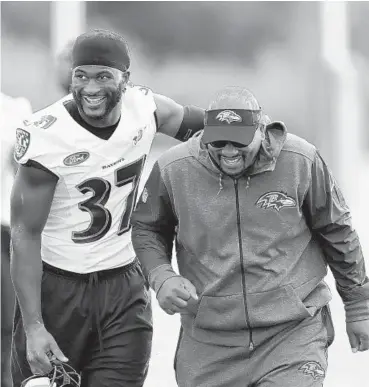  ?? MATT DUNHAM/ASSOCIATED PRESS PHOTOS ?? Ravens running back Buck Allen, left, walks off the field with a coach after a practice session at London Irish Training Ground, a rugby facility. Allen could be the primary ball carrier for the Ravens on Sunday.