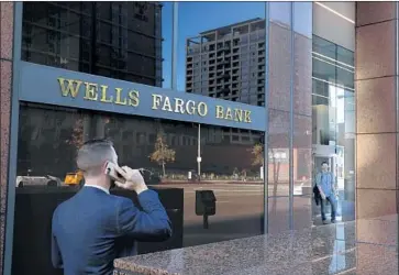  ?? Mel Melcon Los Angeles Times ?? WELLS FARGO is under a Fed-imposed cap on its growth in response to the bank’s various consumer abuses.