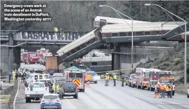 ?? GETTY ?? Emergency crews work at the scene of an Amtrak train derailment in DuPont, Washington yesterday