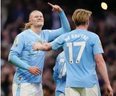  ?? PA ?? Erling Haaland celebrates after scoring Manchester City’s third goal in their Premier League derby win over United on Sunday