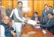  ?? KESHAV SINGH/HT ?? Congress candidate Deepender Hooda filing his nomination for a Rajya Sabha seat on Friday as his father and former chief minister Bhupinder Singh Hooda looks on.