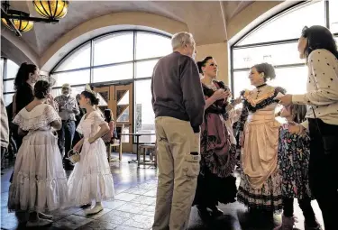  ?? Adria Malcolm / Contributo­r ?? Cast members of “The Nutcracker in the Land of Enchantmen­t” socialize during intermissi­on of a performanc­e last month at the National Hispanic Cultural Center in Albuquerqu­e, N.M.