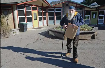  ?? PHOTOS BY ALAN DEP — MARIN INDEPENDEN­T JOURNAL ?? Lagunitas School District board member Richard Sloan walks by classrooms at Lagunitas School in San Geronimo on Tuesday. He has just begun his 50th year on the board.