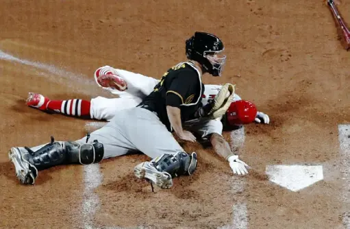  ?? Associated Press ?? St. Louis Cardinals second baseman Kolten Wong is tagged out at home by Pirates catcher Jacob Stallings to save a run.