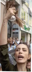  ?? ?? Symbol of defiance: Women cut their hair off outside Iran’s embassy in Istanbul and, left, protests in Tehran on Saturday