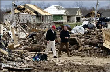  ?? ALEX BRANDON — THE ASSOCIATED PRESS ?? President Donald Trump speaks with Mike Herrick, with Putnam County Rescue Squad, as he tours damage from a recent tornado Friday in Cookeville, Tenn.