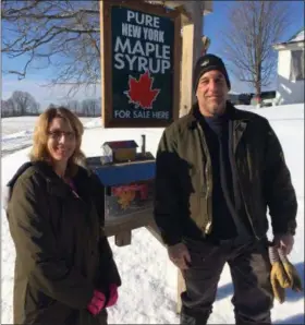  ?? PAUL POST - MEDIANEWS GROUP ?? Ideal maple producing temperatur­es are expected this weekend. Greg Lapan, right, and his fiance, Janet Oliver, left, run Battlehill Maple in Fort Ann.