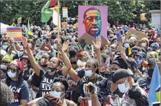  ?? Kathy Willens / Associated Press ?? Almost six months after George Floyd’s death, criminal justice reform advocates are cheering victories in the 2020 election. Above, people participat­e June 14 in a Caribbean-led Black Lives Matter rally in Brooklyn.