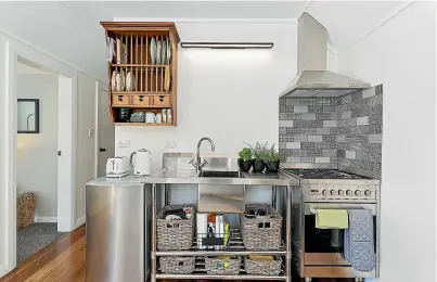  ?? LOWE & CO REALTY ?? Above, the unfitted kitchen features a stainless steel bench with integrated sink, and stainless steel oven; left, The owners describe their project as a ‘‘labour of love’’.