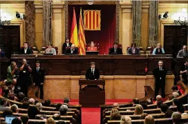  ?? DAVID RAMOS / GETTY IMAGES ?? Catalan President Carles Puigdemont speaks Tuesday to the Catalan Parliament in Barcelona. He recommende­d that the regional parliament suspend its drive for independen­ce from Spain to pursue a dialogue with Madrid.