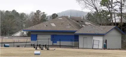  ?? The Sentinel-record/donald Cross ?? ■ Roof and fence damage is shown to the concession area at Don Phillips Field Thursday afternoon. The district will adopt a plan at this Thursday’s school board meeting.