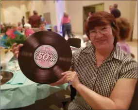  ?? PHOTOS BY PAUL POST — MEDIANEWS GROUP ?? Connie Marcy of Ballston Spa Area Seniors holds a replica Fabulous 50s record. A native of Great Falls, Montana, she will be celebratin­g her 50th high school graduation next month.